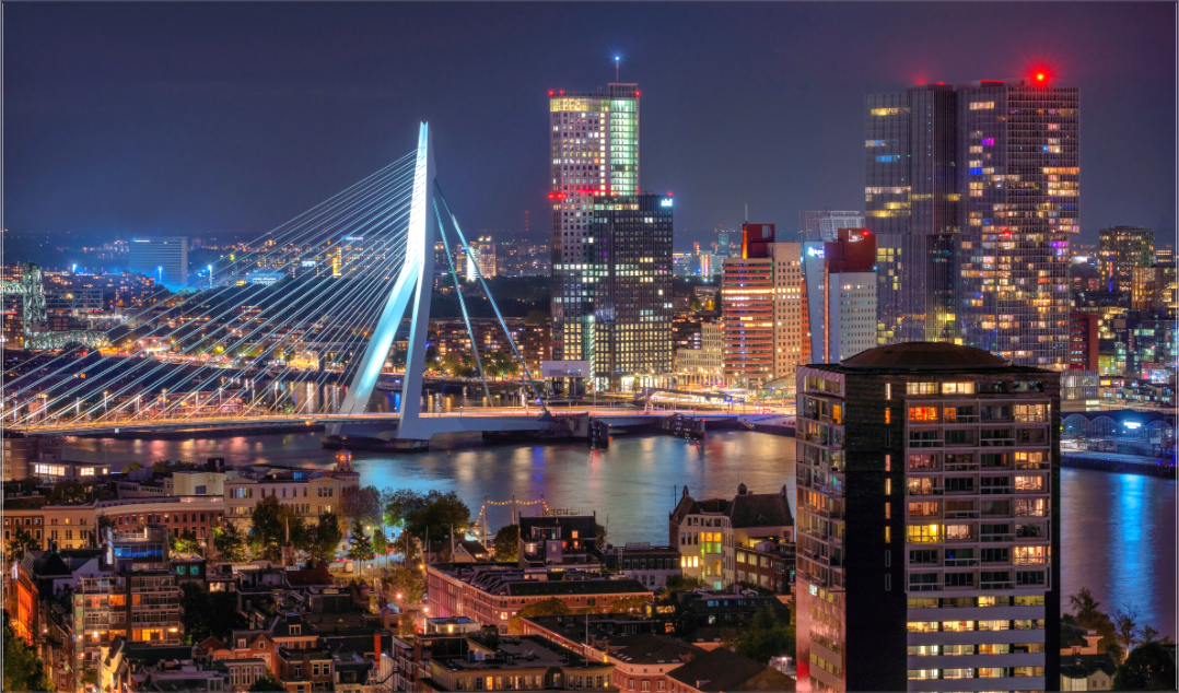 Erasmusbrug in Rotterdam bij nacht met verlichte skyline en reflecties – stedelijke Nederlandse wanddecoratie.